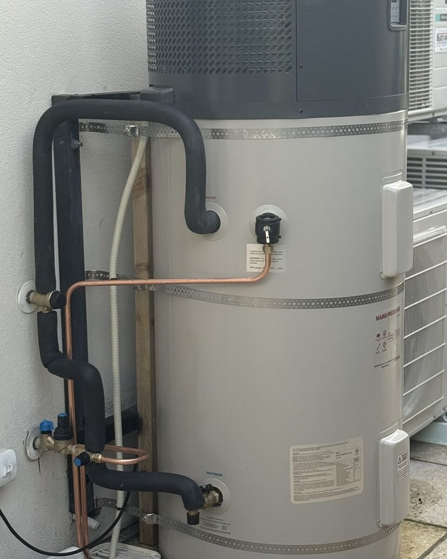 Heat pump cylinder with insulated pipework
